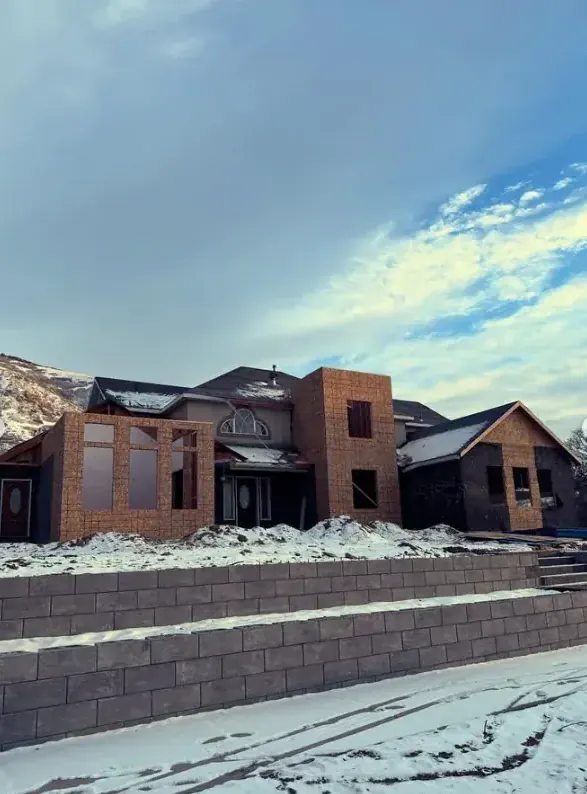 New custom home exterior during large framing build by Frame Platinum LLC