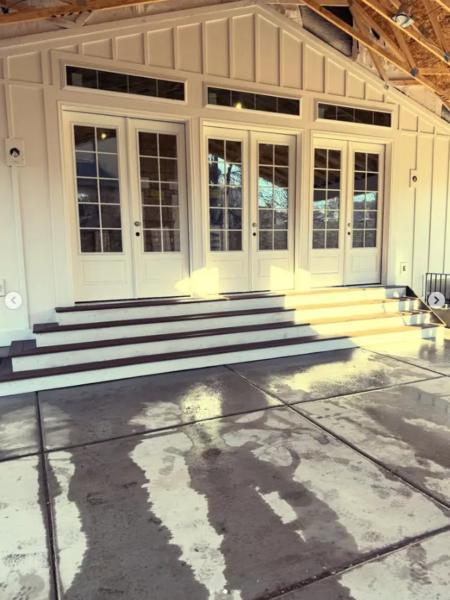 Long front steps and entry by Frame Platinum LLC