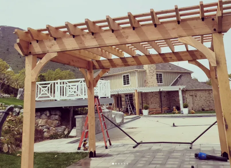 Large cedar pergola over a backyard patio by Frame Platinum LLC