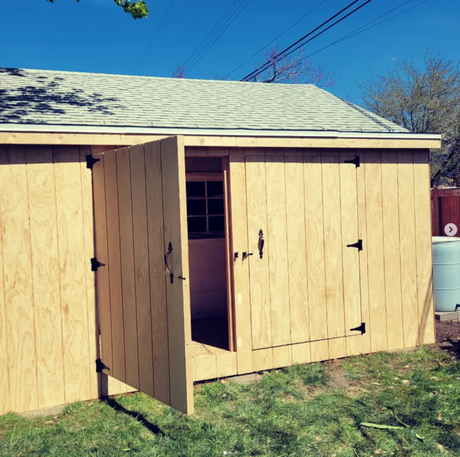 Freshly built shed with open barn-style door by Frame Platinum LLC
